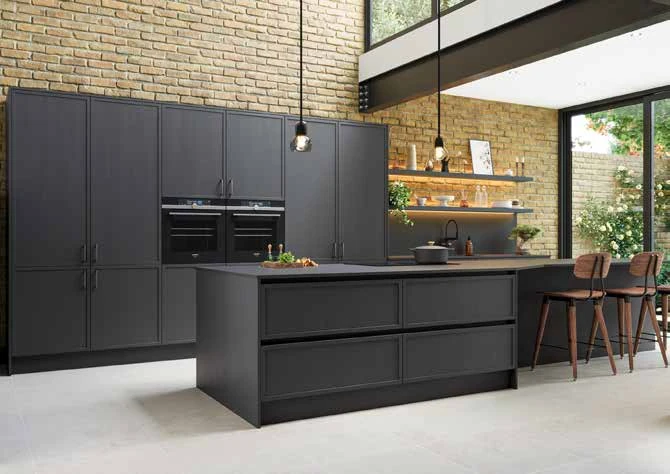 Dark micro-shaker kitchen with slim framing and warm timber shelving