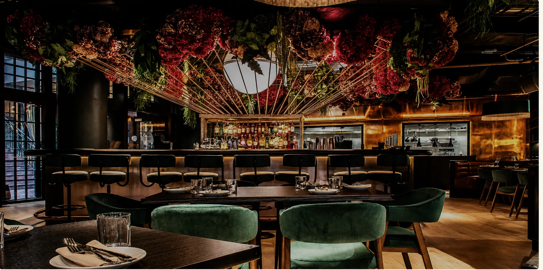 Virgin Hotel restaurant interior with a floral ceiling installation and central bar